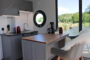 a kitchen with a counter and a sink and a window at Hausboot Schwanennest in Kirchberg an der Raab