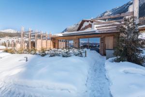 a house with snow in front of it at Aura Chalets - Nr 4 in Castelrotto