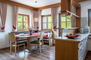 a kitchen and dining room with a table and chairs at Rotkäppchen Schlosshof in Völs am Schlern