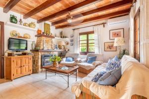 a living room with a couch and a fireplace at Villa Can Sol in Pollença