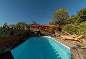 a swimming pool with two chairs and a house at Villa Casablanca in Montferrer