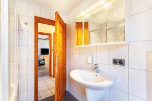 a bathroom with a sink and a mirror at Ferienwohnung Busch in Meinerzhagen +11 photos