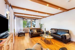 a living room with a couch and a table at Ferienwohnung Busch in Meinerzhagen