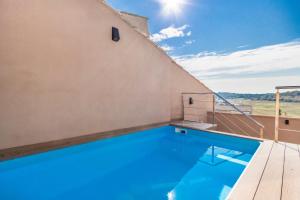 a swimming pool on the roof of a house at Cal Comorera in Masoteras