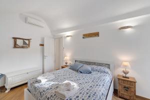 a bedroom with a bed with a blue comforter at Bedliving Nel Blu in Genoa