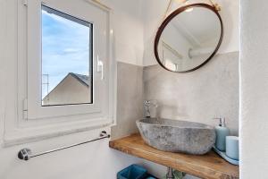 a bathroom with a stone sink and a mirror at Bedliving Nel Blu in Genoa +32 photos