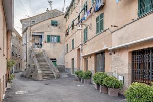 an alley with stairs between two buildings with plants at Bedliving Nel Blu in Genoa