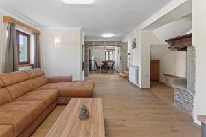 a living room with a couch and a table at Holiday Home Pahari by Rent Istria in Roč