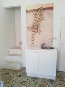 a bathroom with a sink and a wall at Vista Castello - Otranto in Otranto