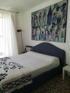 a bedroom with a bed with a painting on the wall at Vista Castello - Otranto in Otranto +23 photos
