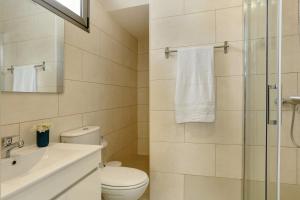 a bathroom with a toilet and a sink and a shower at Albamar 1d in Puerto de Mogán