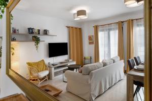a living room with a white couch and a tv at Alpispa in Arrecife