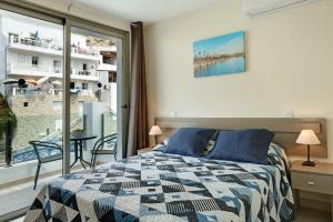 a bedroom with a bed and a large window at Albamar 1d in Puerto de Mogán