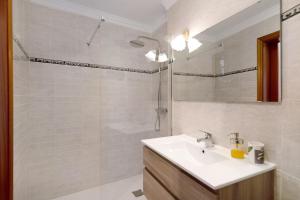 a bathroom with a sink and a shower at Alpispa in Arrecife +12 photos