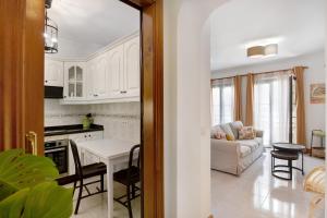 a kitchen and living room with white cabinets at Alpispa in Arrecife