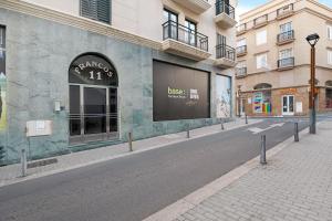 an empty street in a city with a building at Alpispa in Arrecife