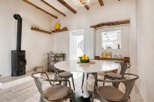 a dining room with a table and chairs and a stove at Mirasol in Benitachell
