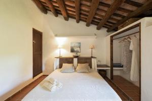 a bedroom with a large white bed with two pillows at La Isla Verde in Els Hostalets +37 photos