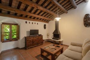 a living room with a couch and a stove at La Isla Verde in Els Hostalets