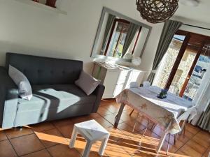 a living room with a couch and a table at Apartament Potxó in Olp +14 photos