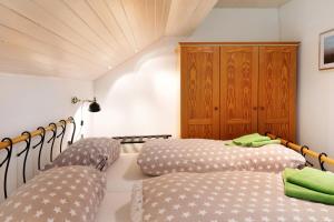 a room with two beds and a wooden cabinet at Feldbergstern in Feldberg