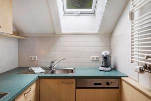a small kitchen with a sink and a window at Feldbergstern in Feldberg +17 photos