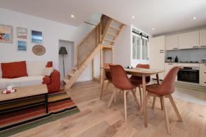 a living room with a table and chairs and a staircase at Ker Mam - Belle-Ile in Sauzon