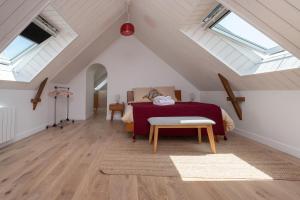 a attic bedroom with a bed and skylights at Ker Mam - Belle-Ile in Sauzon