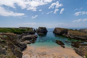 a view of a beach with rocks and the ocean at Ker Mam - Belle-Ile in Sauzon