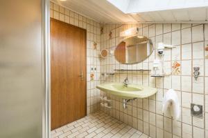a bathroom with a sink and a mirror at Residence Kronstein - Fewo 8 in Tesimo +12 photos