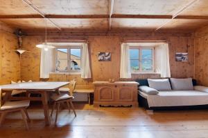 a living room with a table and a couch at Bertollhof Apfelerlebnis in Silandro