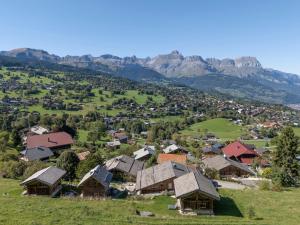 a village in a valley with mountains in the background at Mazot de la Pointe Percée in Combloux