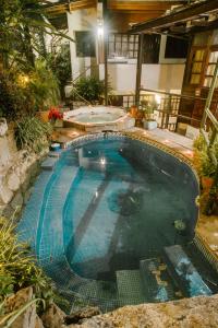 a swimming pool in the middle of a house at Gringo Bill's Boutique Hotel in Machu Picchu