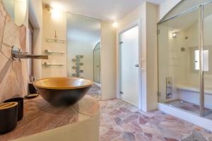 a bathroom with a large wooden bowl on a counter at Villa Amalthea - sea view-wellness in Costa Paradiso