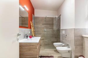 a bathroom with a sink and a toilet and a shower at L'antica corte apt Angelina in Levico Terme +21 photos
