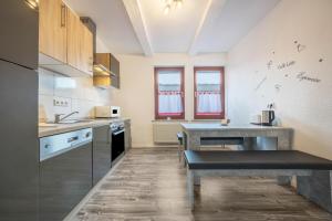 a kitchen with a sink and a table in it at Ferienwohnung Bartölke in Bockenem