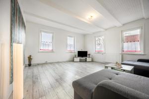 a living room with a couch and a tv at Ferienwohnung Bartölke in Bockenem
