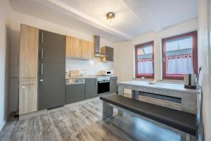 a kitchen with stainless steel appliances and wooden cabinets at Ferienwohnung Bartölke in Bockenem +13 photos
