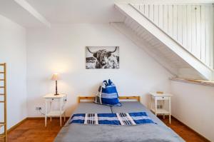 a bedroom with a bed with a cow picture on the wall at Appartement Männerleben in Harztor