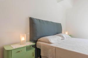 a bedroom with a bed with a candle on a night stand at Casa di Ada in Segonzano