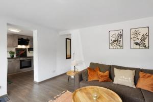 a living room with a couch and a table at Ferienwohnung Selbecke in Kirchhundem