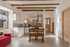 a kitchen and dining room with a table and chairs at Casa di Ada in Segonzano +19 photos
