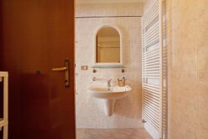 a bathroom with a sink and a mirror at Stella del Garda 2 con terrazza in Tignale +22 photos