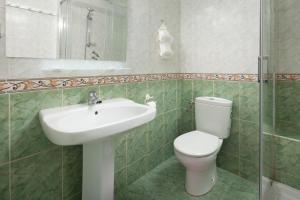 a bathroom with a toilet and a sink at Casa Santo front beach in Cala del Moral +17 photos