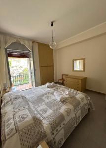 a bedroom with a large bed and a window at La pineta Apartment Tropea in Tropea
