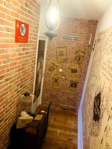 a room with a brick wall and a staircase at Le refuge des Mans-raudeurs in Le Mans