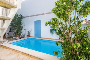 a swimming pool in a house with a tree at Casa Cantino in Santa Margalida