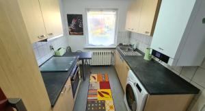 a kitchen with a sink and a washing machine at Haus im Grünen in Hoppegarten