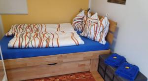 a bedroom with a bed with blue sheets and pillows at Haus im Grünen in Hoppegarten