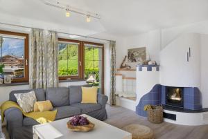 a living room with a couch and a fireplace at Zillertalblick in Zellberg